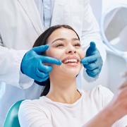 a patient checking their white smile with a mirror