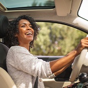 Woman smiling while driving