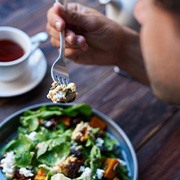Man about to eat forkful of healthy salad