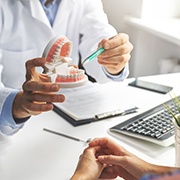 a dentist explaining the cost of dentures in Los Alamitos