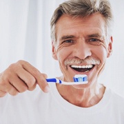 Man brushing his dental implants in Los Alamitos