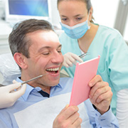 Man smiling into mirror