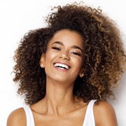 a woman smiling with newly brightened teeth