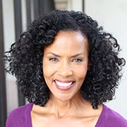 Woman in purple top with beautiful smile looking at camera