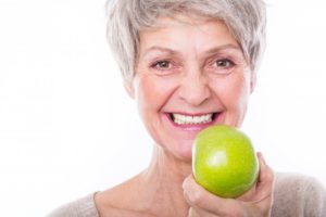 senior woman smiling apple