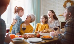 family sitting down to Thanksgiving dinner