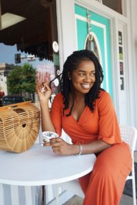 Woman with dental implants at outdoor table