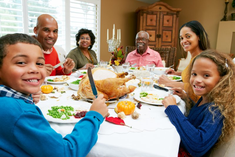 family enjoying Thanksgiving dinner with dentures in Los Alamitos