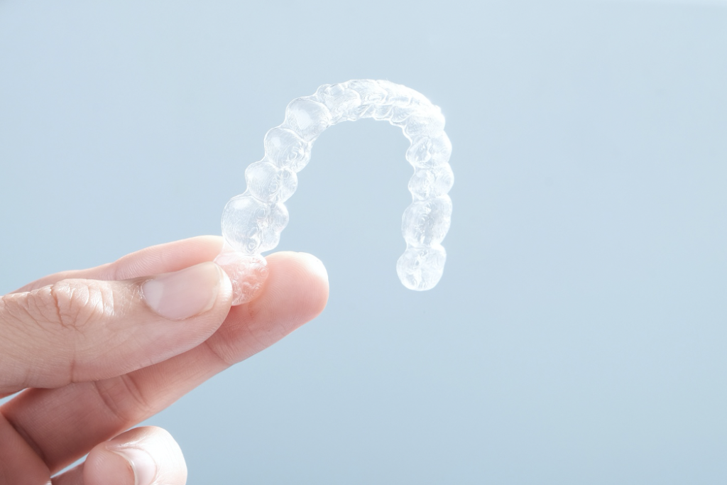 Person holding Invisalign braces