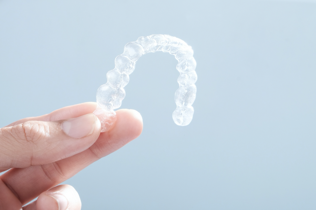 Person holding Invisalign braces 