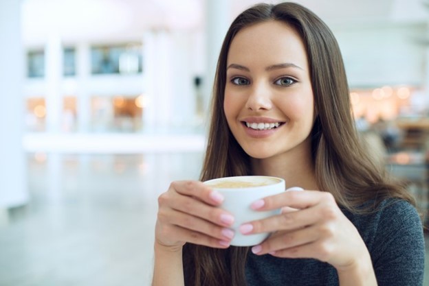 person holding a cup of coffee 